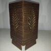 Artisan-crafted wooden lampshade with leaf motif, eco-friendly.