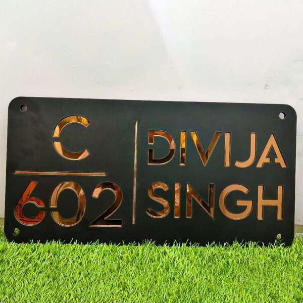 Customizable acrylic name plate with golden letters, adding a touch of elegance to any space.